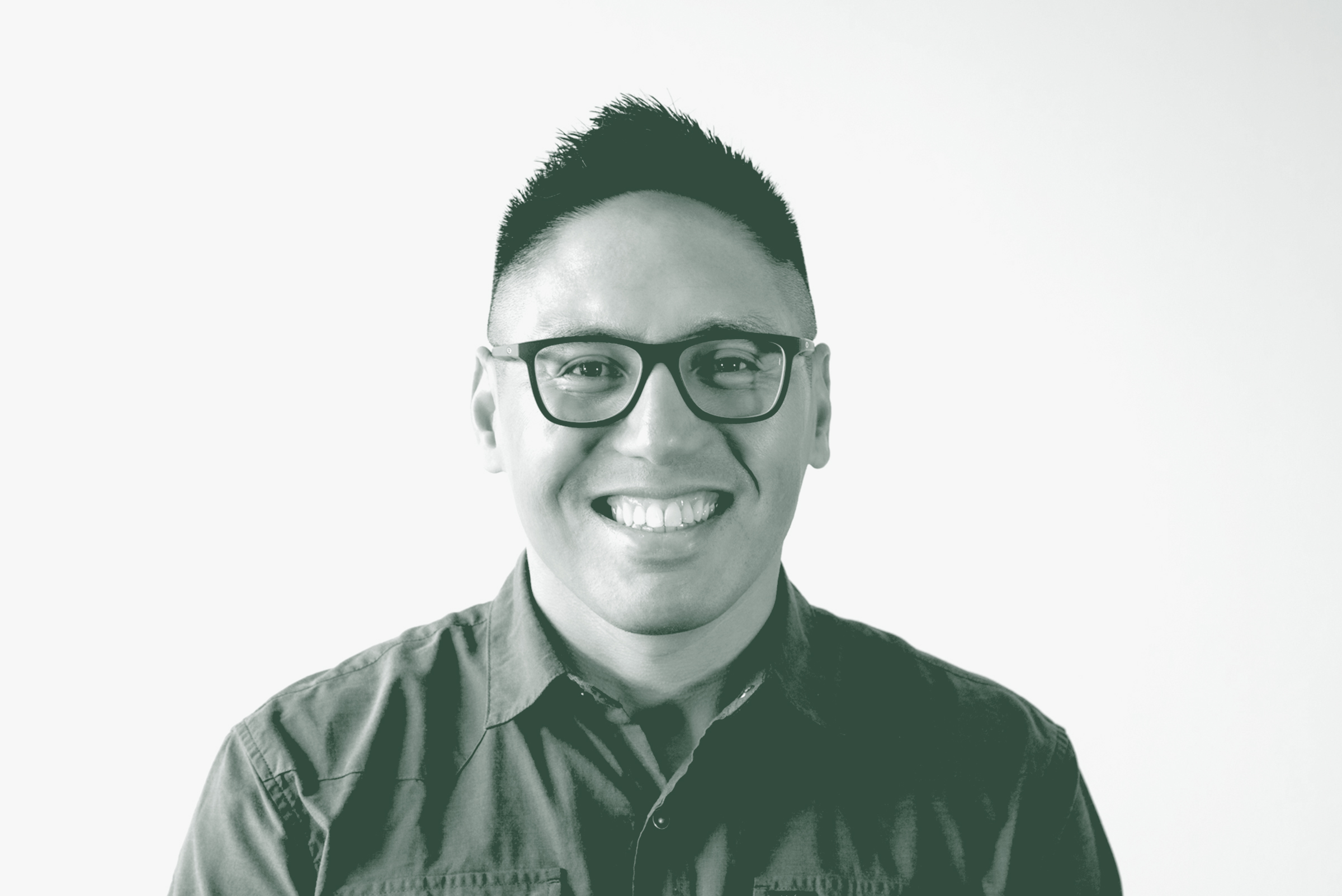 A black and white portrait of Lance Abaya, an Associate and Senior Design Leader with GFF in the Retail & Hospitality Studio, in front of a white background.