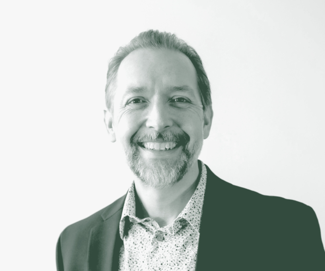 A black and white portrait of Mike Lehr, an Associate Principal and Studio Director with GFF in the Faith & Community Studio, in front of a white background.