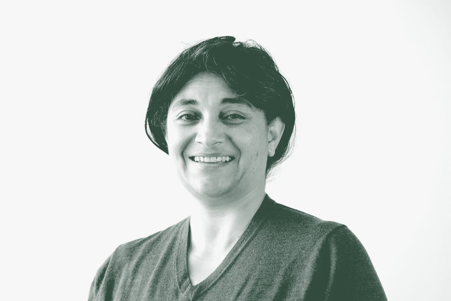 A black and white portrait of Nardine Mansi, an Associate and Senior Project Leader with GFF in the Retail & Hospitality Studio, in front of a white background.