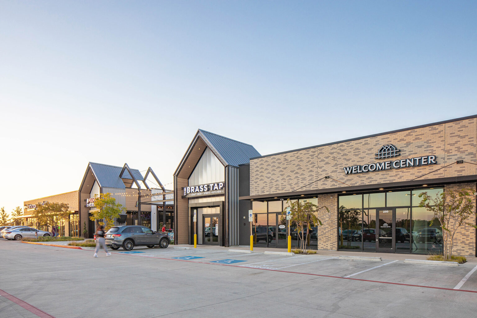 Retail entrance with shared green space at The Station - Sachse, Texas