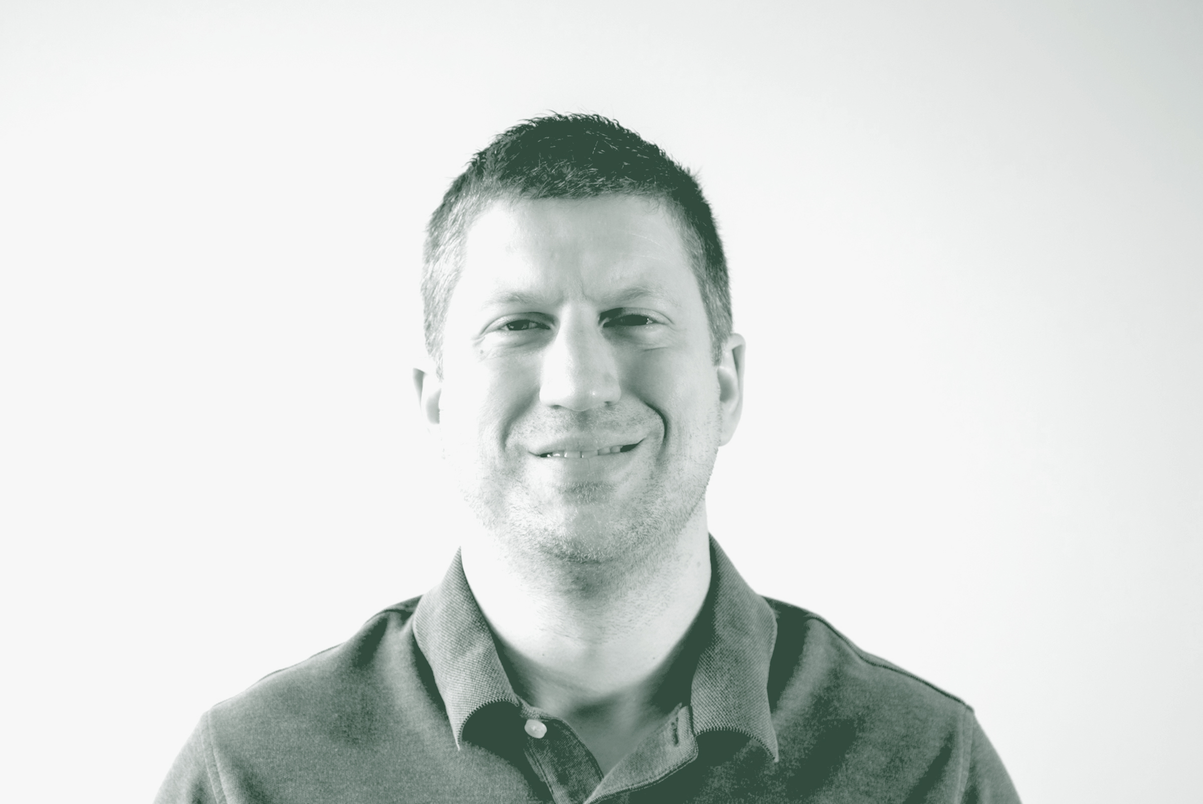 A black and white portrait of Phil DeLaughter, an Associate Principal and the Director of IT and IT Services with GFF, in front of a white background.