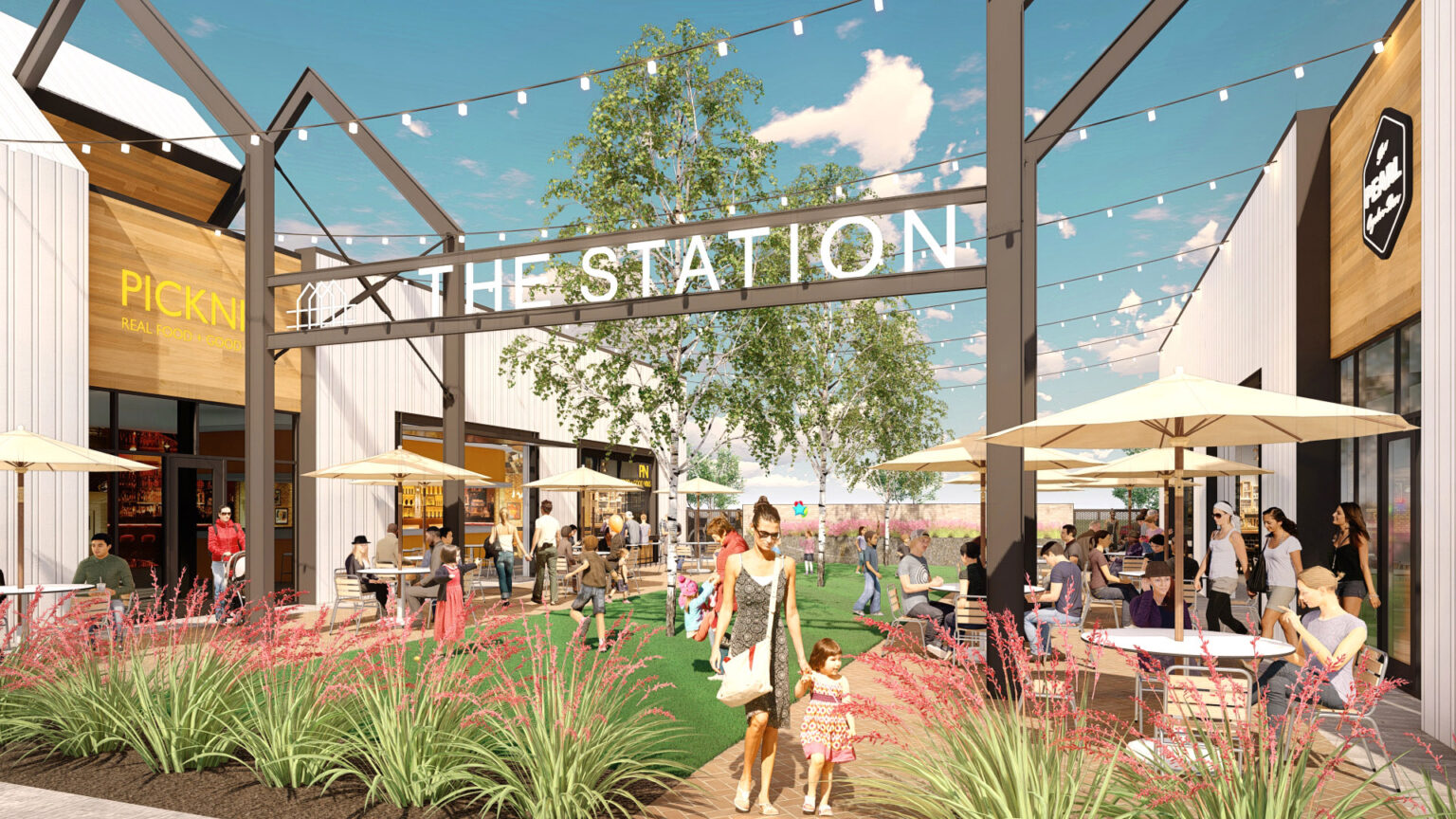 Retail area with green space and seating at The Station - Sachse