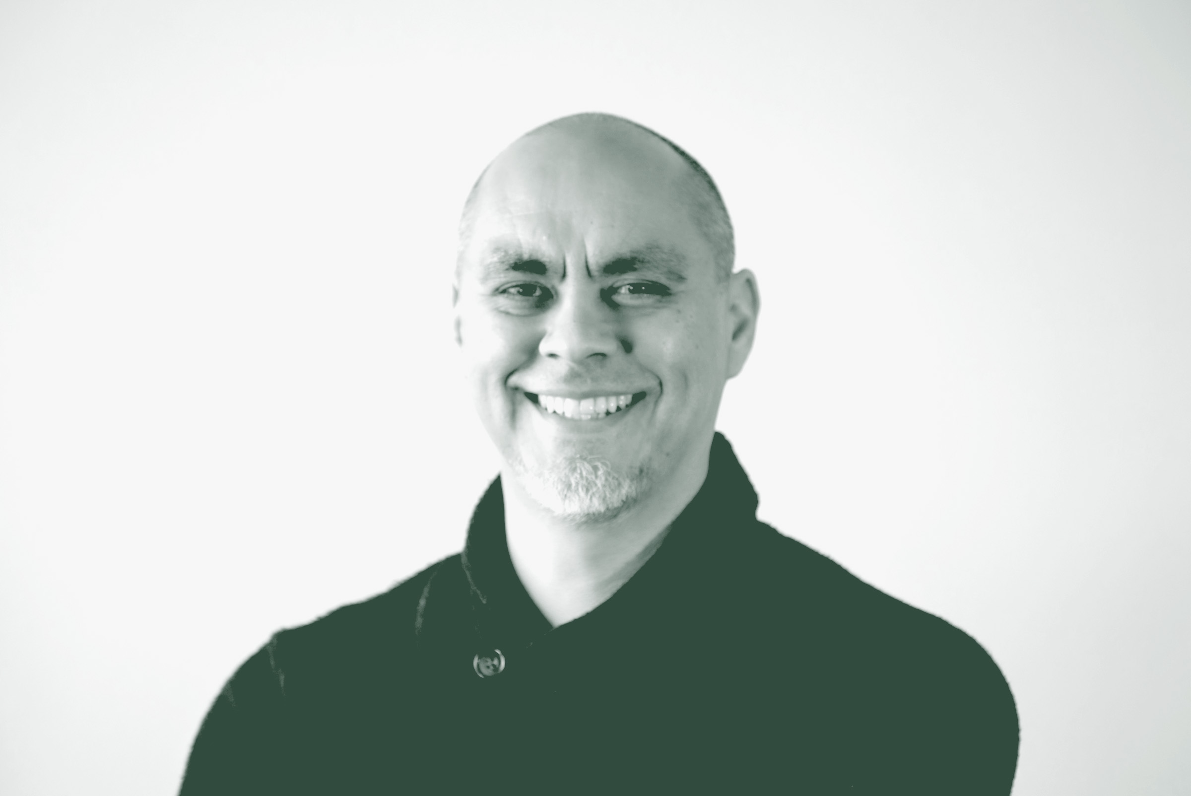 A black and white portrait of Ricardo Montoya, the Technology Principal with GFF, in front of a white background.