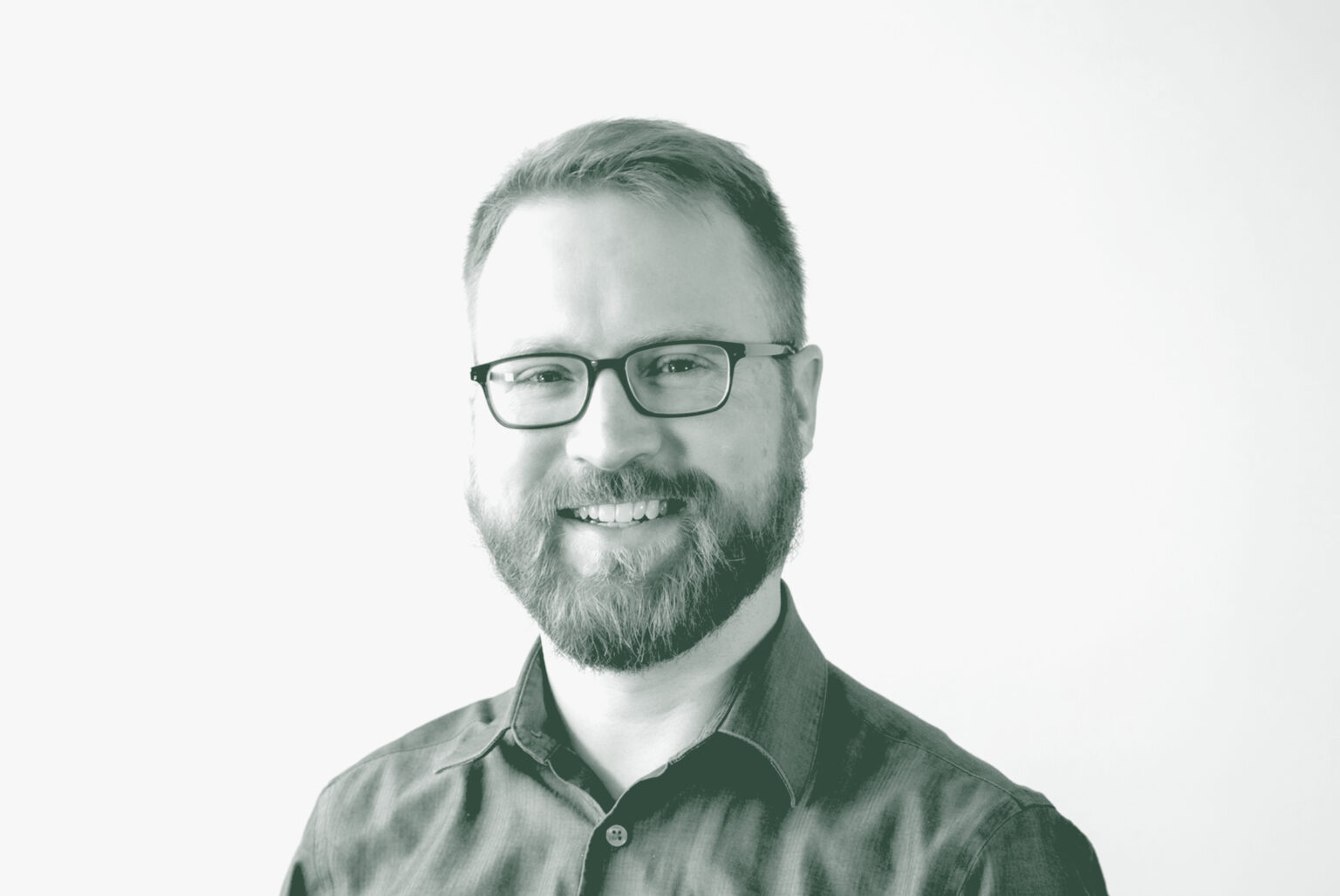 A black and white portrait of Sam Stribling, an Associate and Studio Director with GFF in the Mixed-Use & Multifamily Studio, in front of a white background.