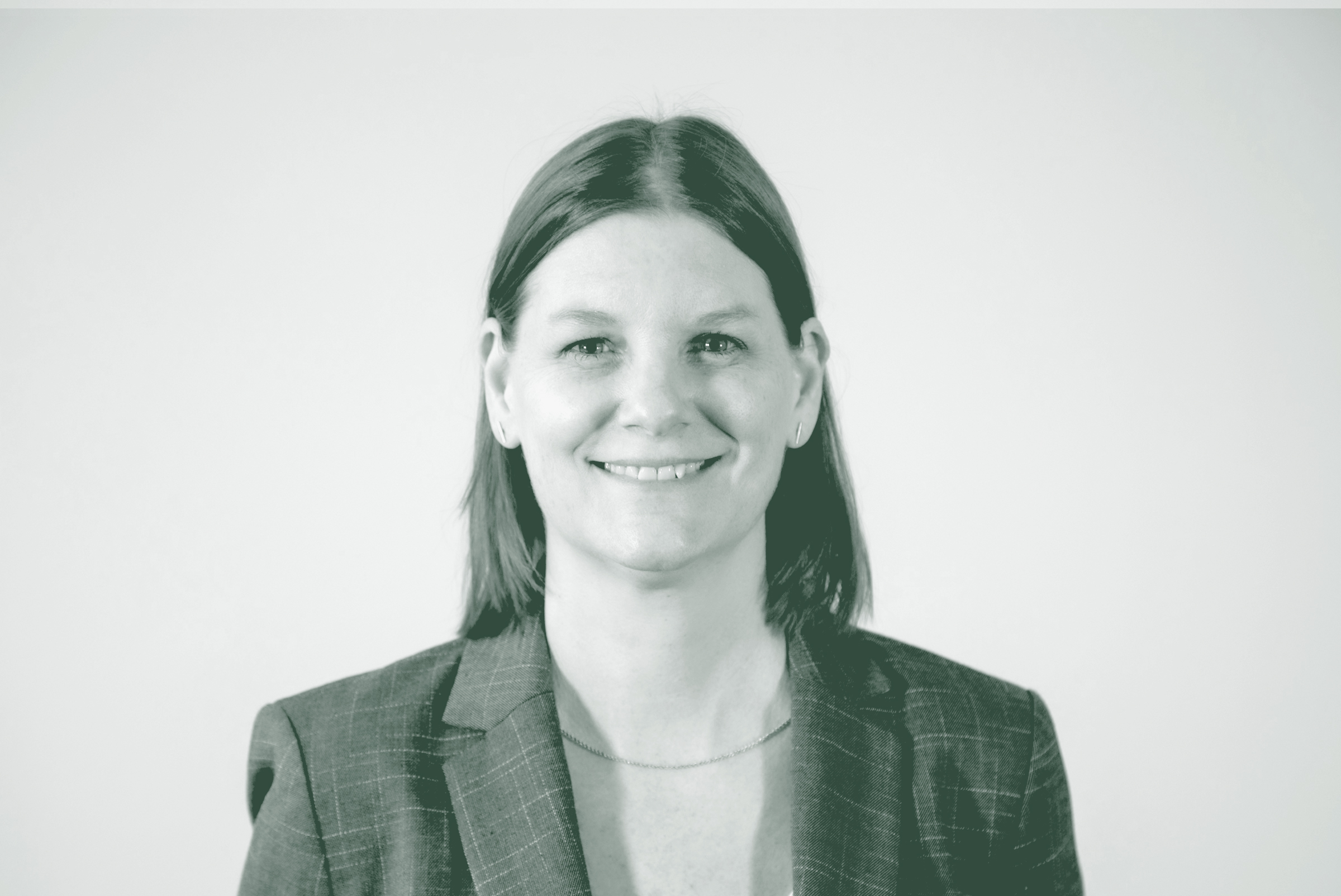 A black and white portrait of Sandra Beer, a Senior Project Leader with GFF in the Faith & Community Studio, in front of a white background.