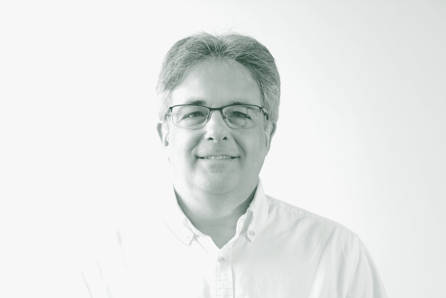 A black and white portrait of Scott Kanaga, an Associate Principal and Studio Director with GFF in the Retail & Hospitality Studio, in front of a white background.