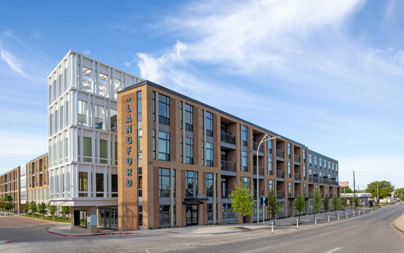 Street view of The Langford's modern four-story residential building with brick detailing, large windows, and balconies.