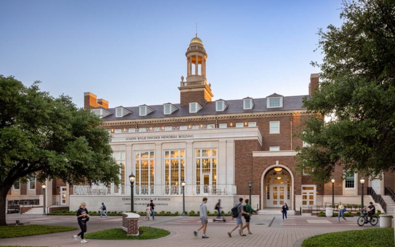Georgian-style exterior of the SMU Cox School of Business with brick facade, cupola, and central entry facing the David B. Miller Business Quadrangle.