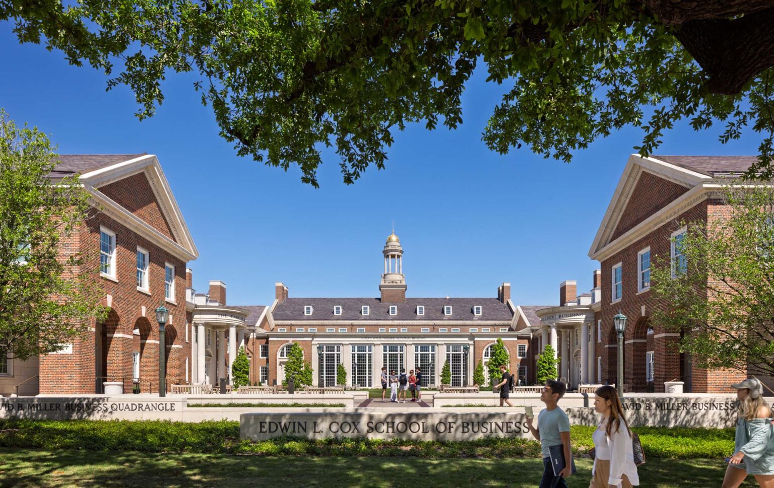 Axial view of the SMU Cox School of Business courtyard with symmetrical Georgian architecture, central commons building, and student activity.