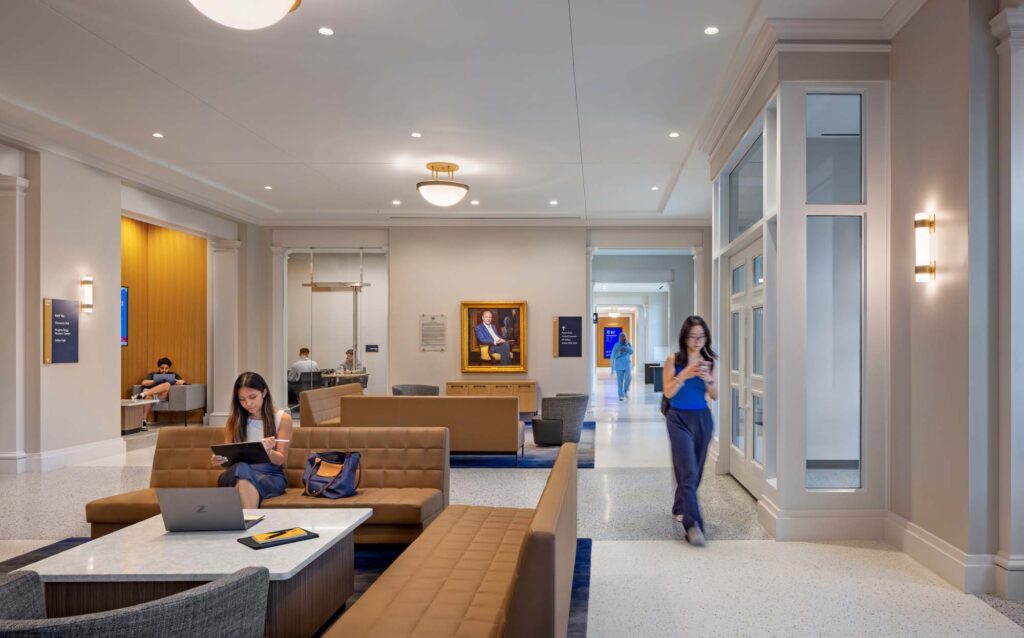 Interior student commons at the SMU Cox School of Business featuring lounge seating, study areas, and circulation corridors with natural light.
