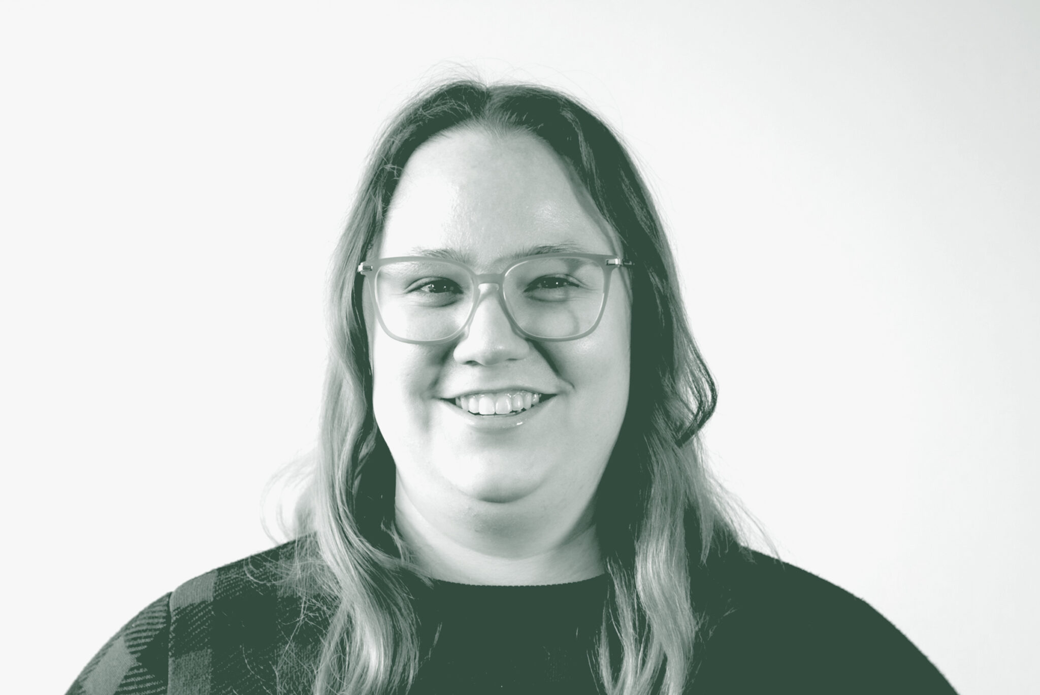 A black and white portrait of Alexis Kaleri, a Senior Project Coordinator with GFF in the Mixed-Use & Multifamily Studio, in front of a white background.