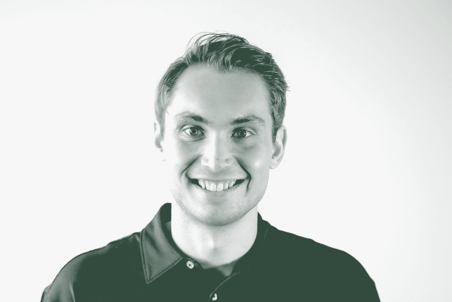 A black and white portrait of Carson Guy, a Project Coordinator with GFF in the Office & Workplace Studio, in front of a white background.