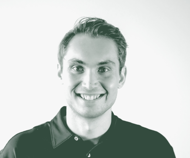A black and white portrait of Carson Guy, a Project Coordinator with GFF in the Office & Workplace Studio, in front of a white background.