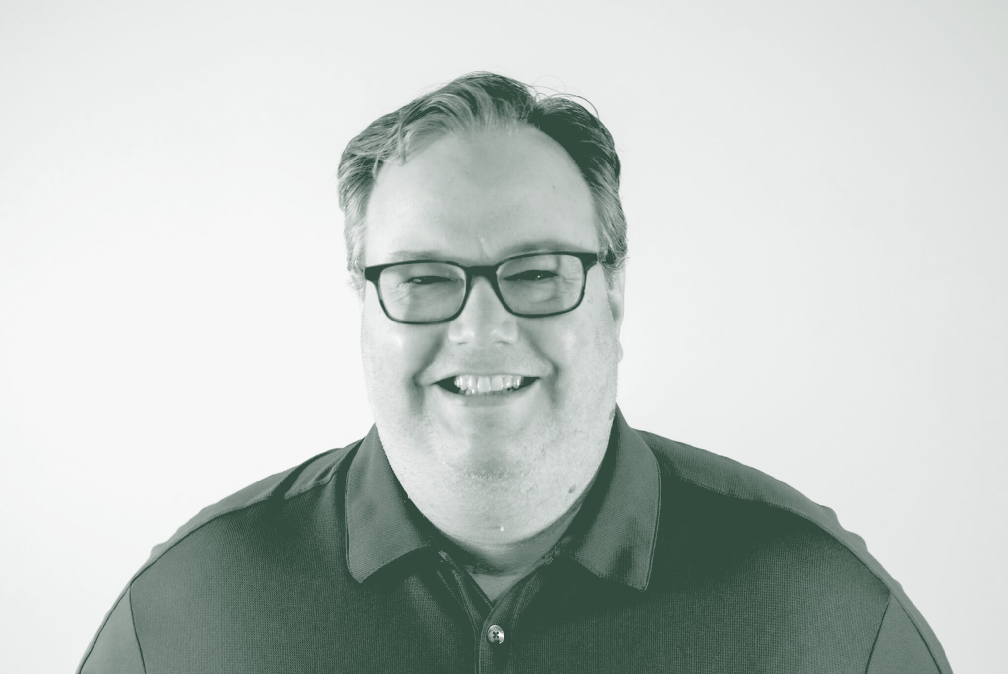 A black and white portrait of Chad Kyzar, a Senior Project Coordinator with GFF in the Fort Worth Studio, in front of a white background.
