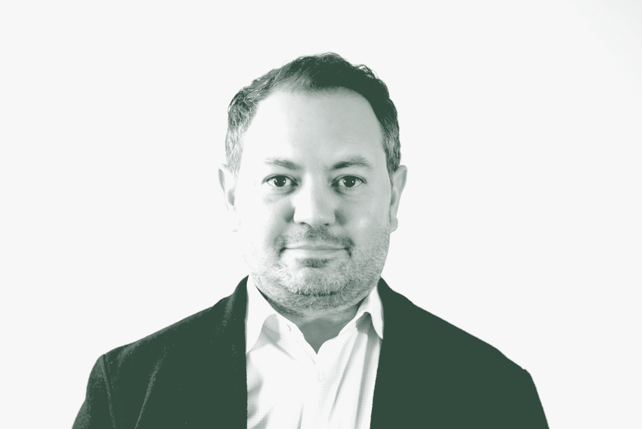 A black and white portrait of David Rosenbloom, a Senior Design Leader with GFF in the Office & Workplace Studio, in front of a white background.
