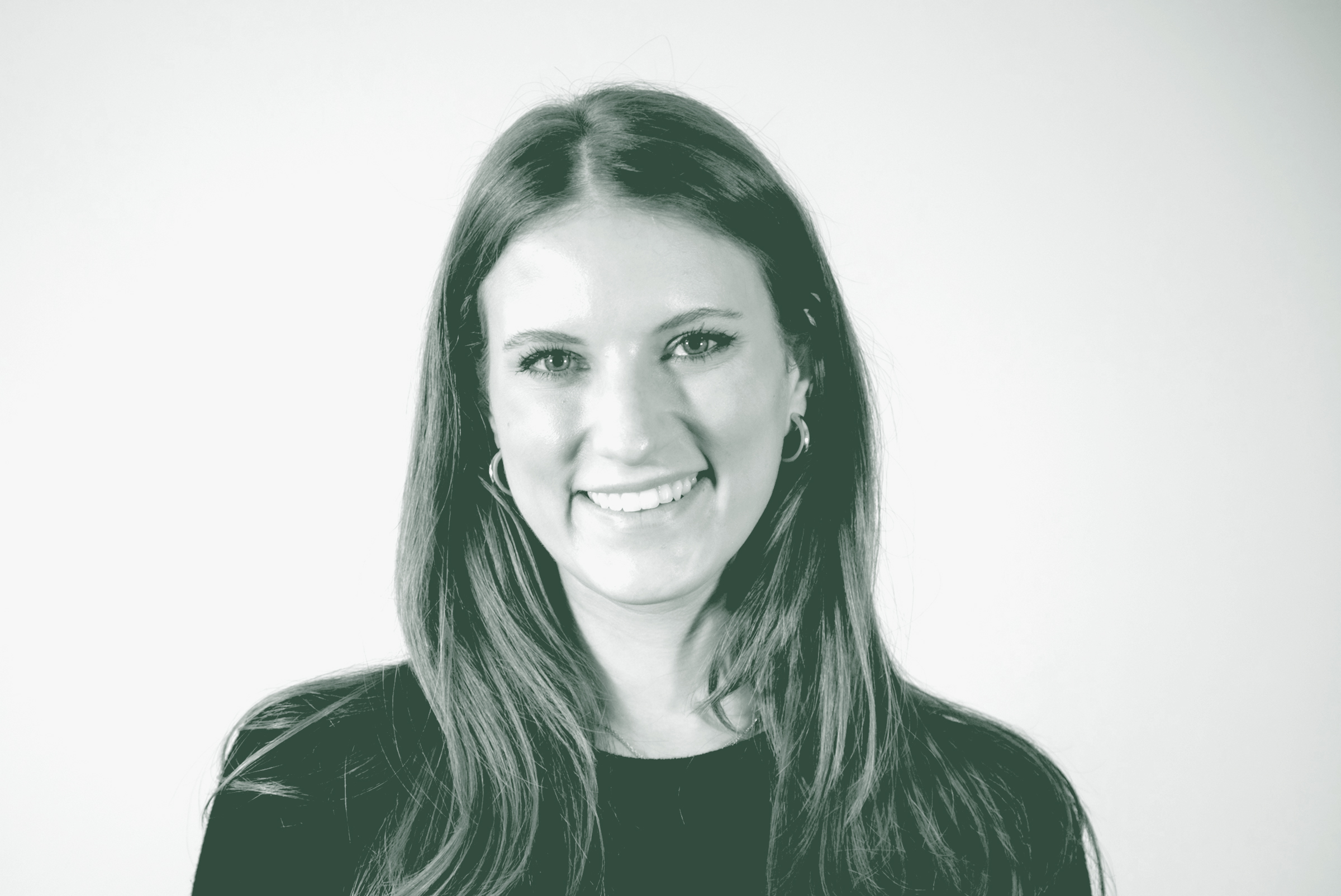 Emily Carvell Portrait A black and white portrait of Emily Carvell, a Marketing Coordinator with GFF, in front of a white background.