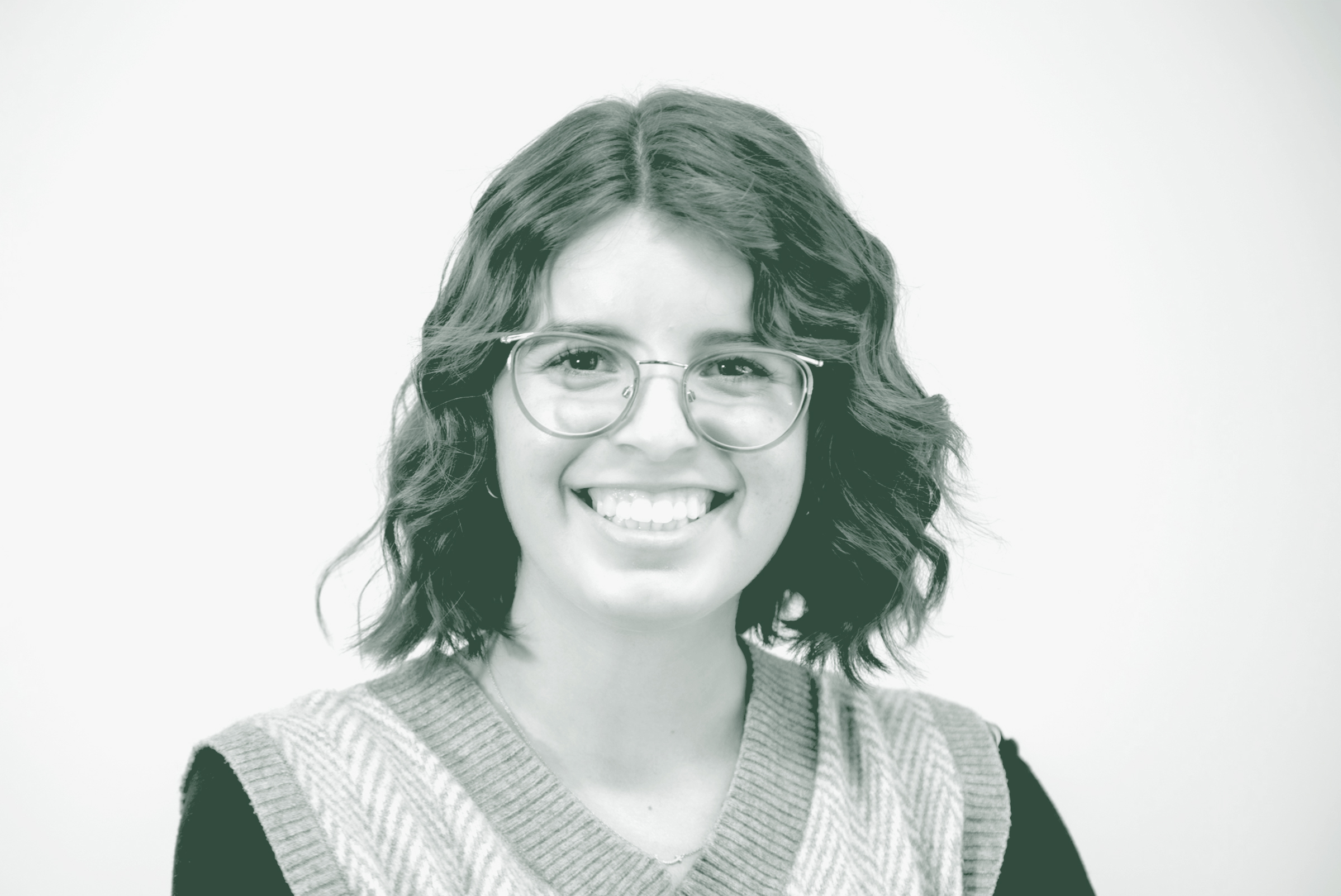 Gabrielle Duran Portrait A black and white portrait of Gabrielle Duran, a Project Coordinator with GFF in the Austin Studio, in front of a white background.