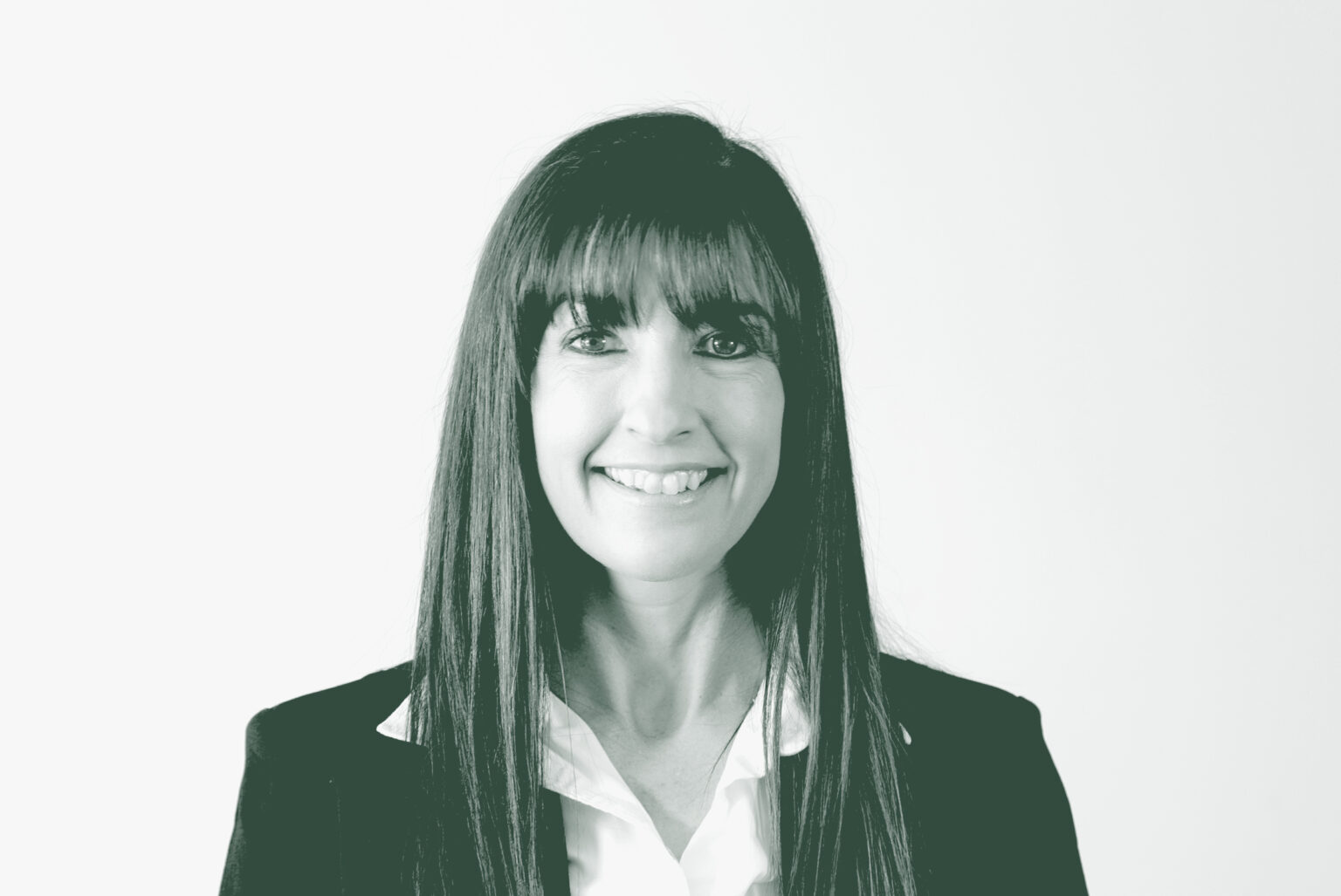 A black and white portrait of Heather Abaya, a Senior Project Coordinator with GFF in the Civic & Cultural Studio, in front of a white background.