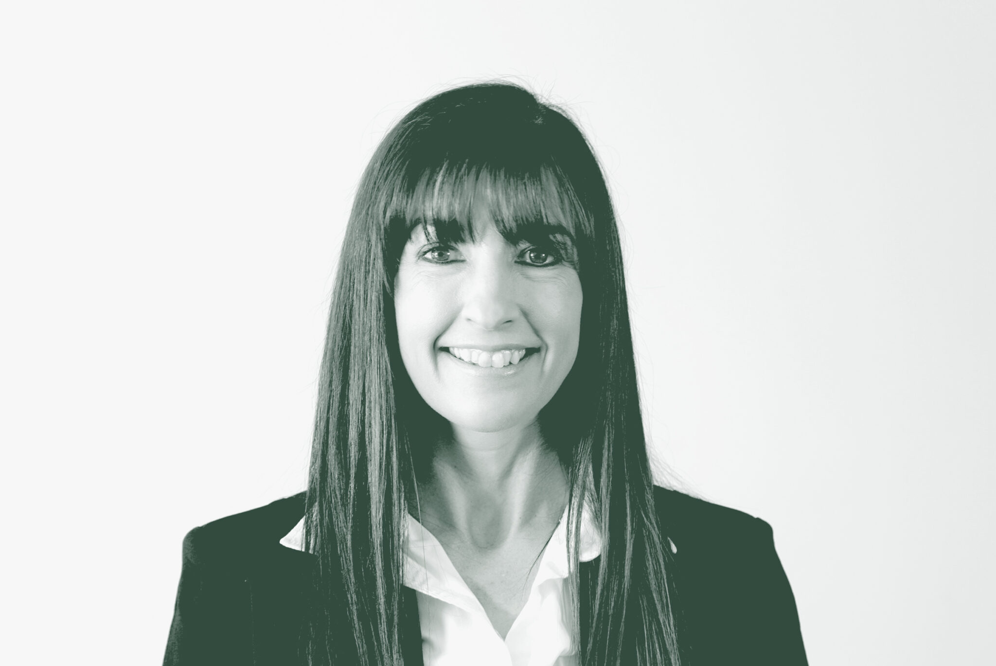 A black and white portrait of Heather Abaya, a Senior Project Coordinator with GFF in the Civic & Cultural Studio, in front of a white background.