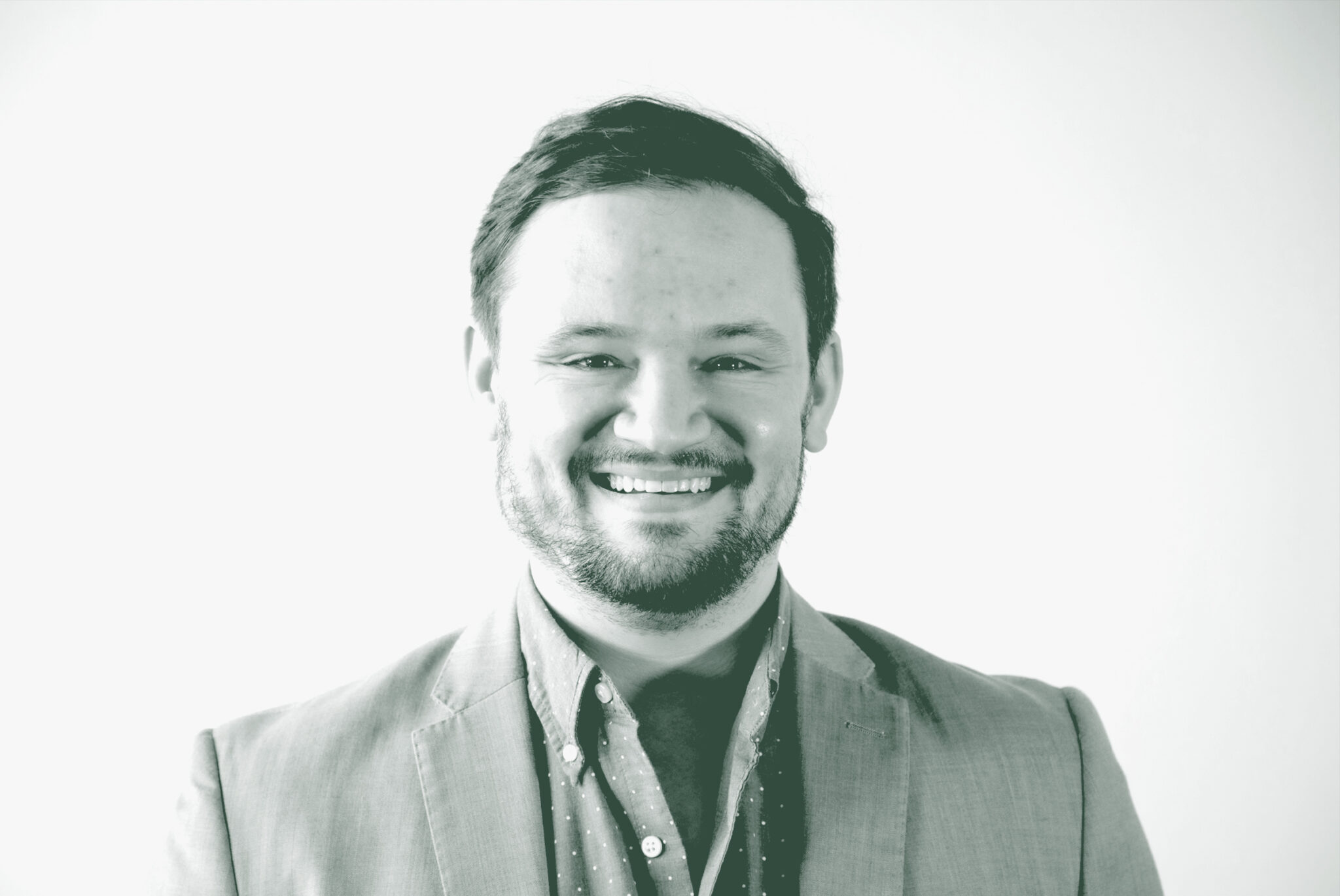 A black and white portrait of Jacob Thibodeaux, a Senior Project Coordinator with GFF in the Mixed-Use & Multifamily Studio, in front of a white background.