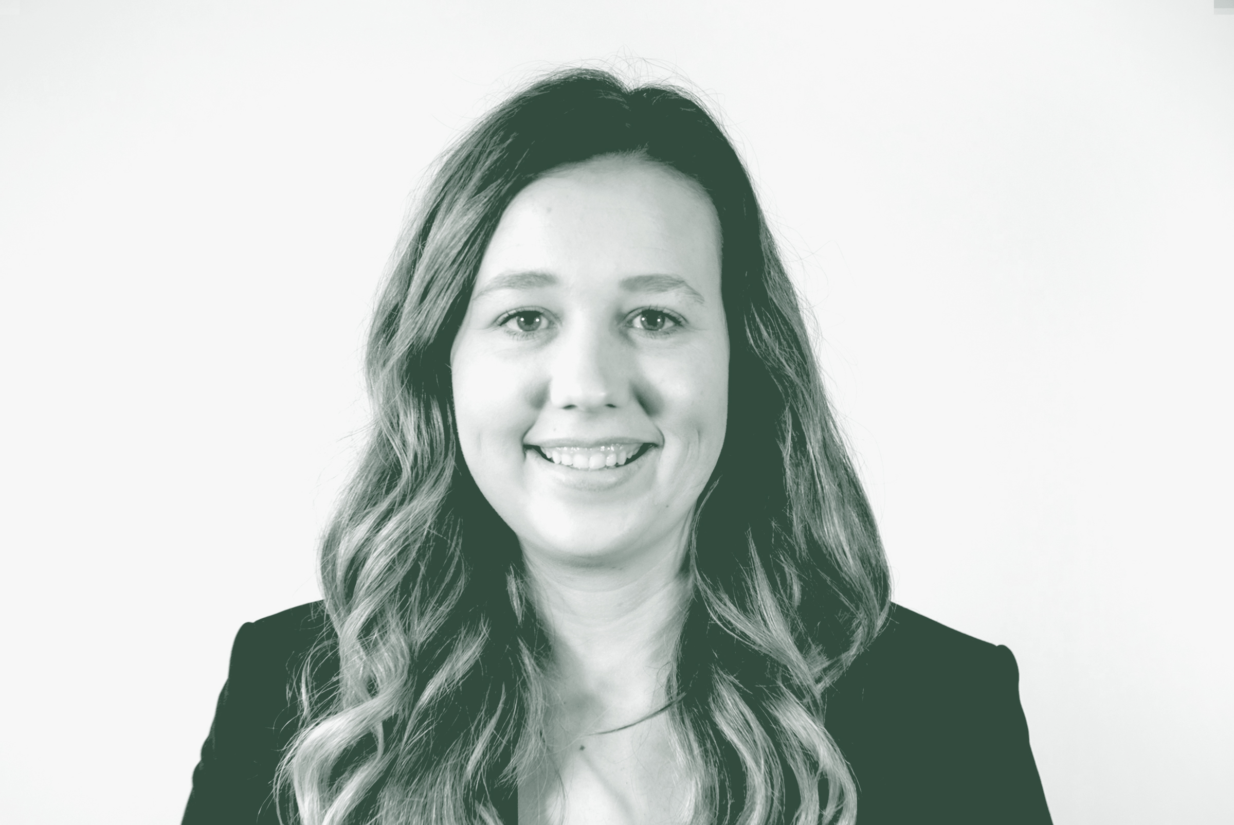 Kelsey Kohlmeier Portrait A black and white portrait of Kelsey Kohlmeier, a Project Coordinator with GFF in the Education Studio, in front of a white background.