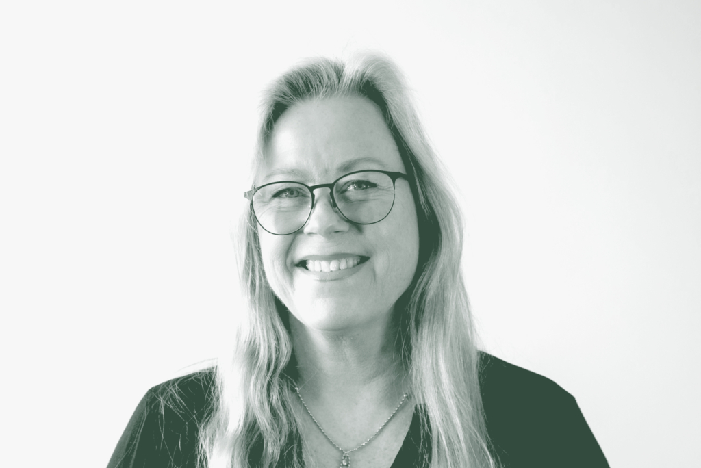 A black and white portrait of Lena Starostine, a Senior Project Coordinator with GFF in the Faith & Community Studio, in front of a white background.