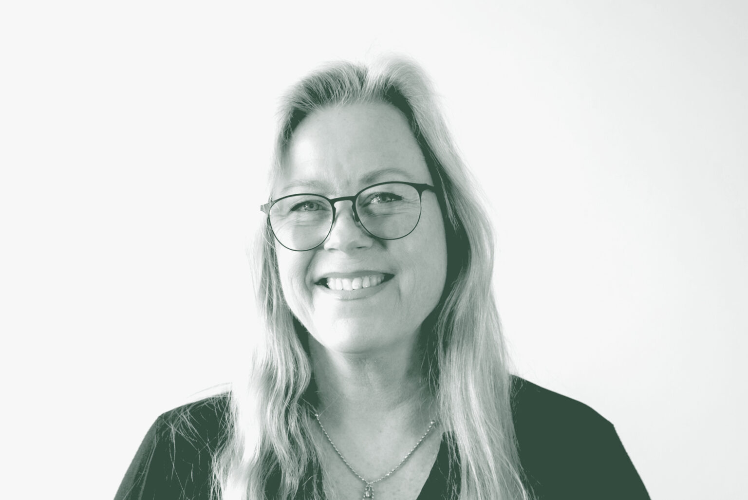 A black and white portrait of Lena Starostine, a Senior Project Coordinator with GFF in the Faith & Community Studio, in front of a white background.