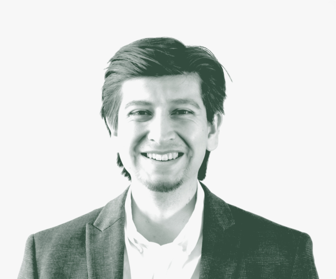 A black and white portrait of Roberto Oviedo, a Senior Project Coordinator with GFF in the Corporate / Office Studio, in front of a white background.