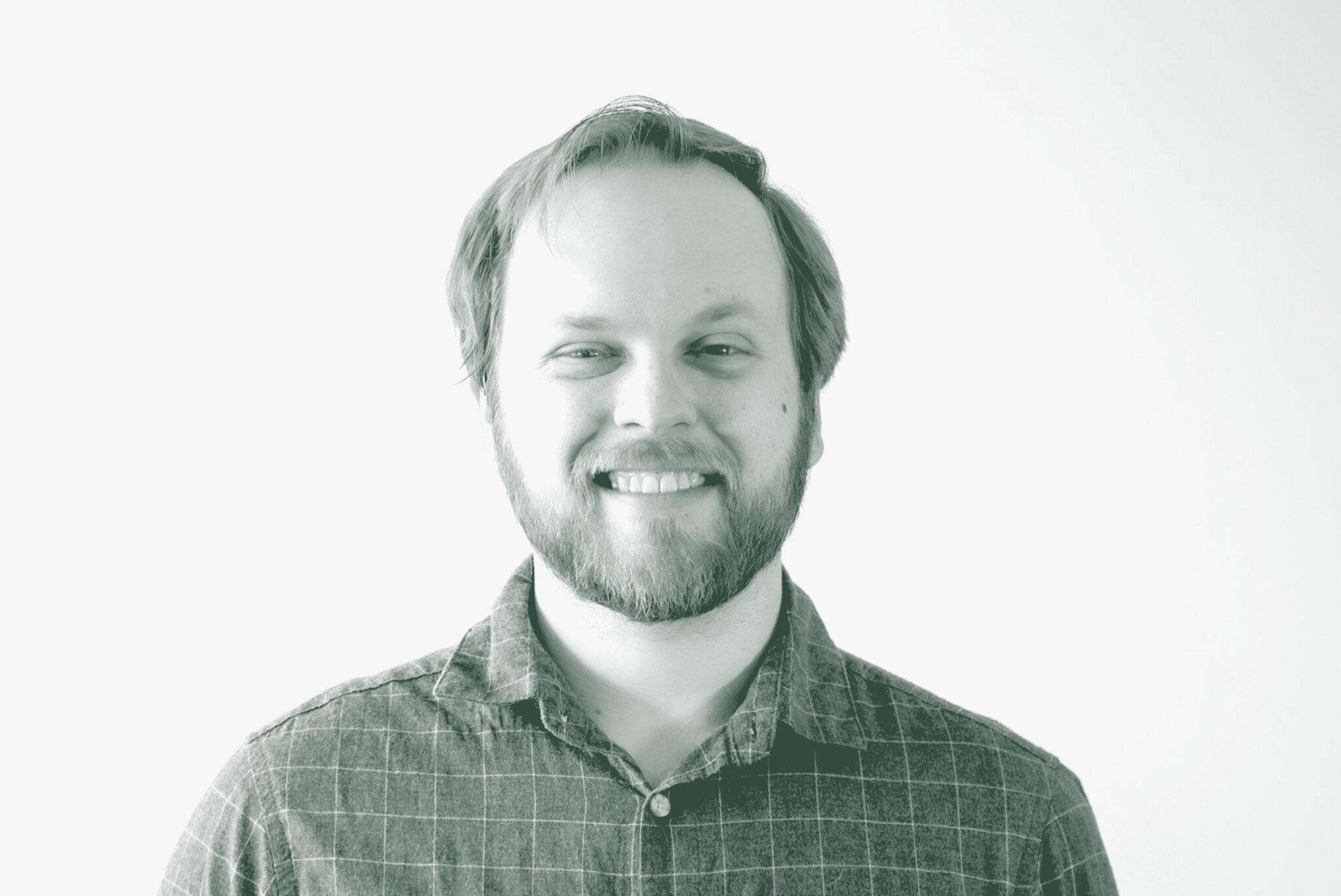 A black and white portrait of Talon McCart, a Senior Project Coordinator with GFF in the Mixed-Use & Multifamily Studio, in front of a white background.