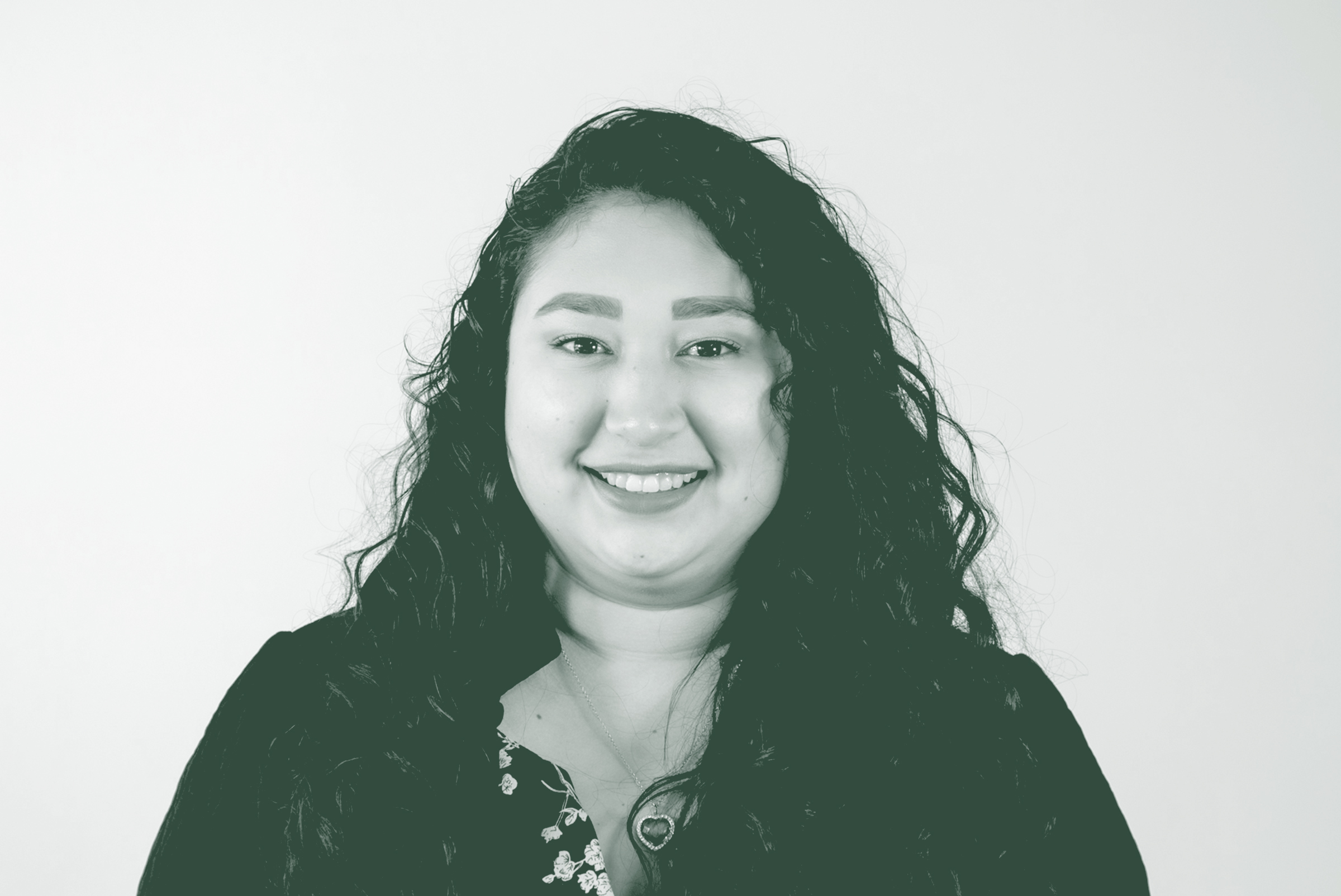 A black and white portrait of Tuesdie Alonso, a Senior Project Coordinator with GFF in the Fort Worth Studio, in front of a white background.