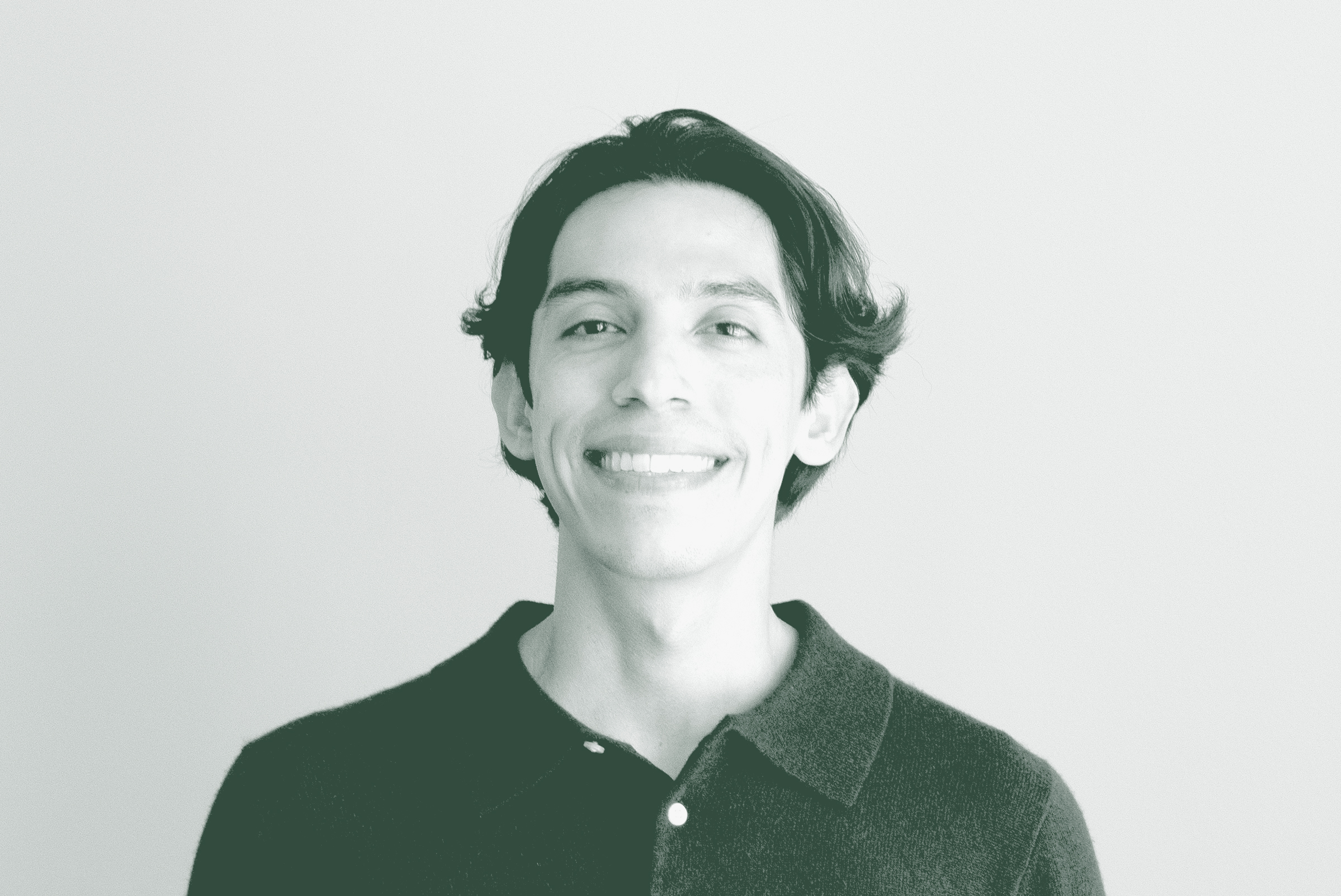 A black and white portrait of Wood Owens, a Project Coordinator with GFF in the Austin Studio, in front of a white background.