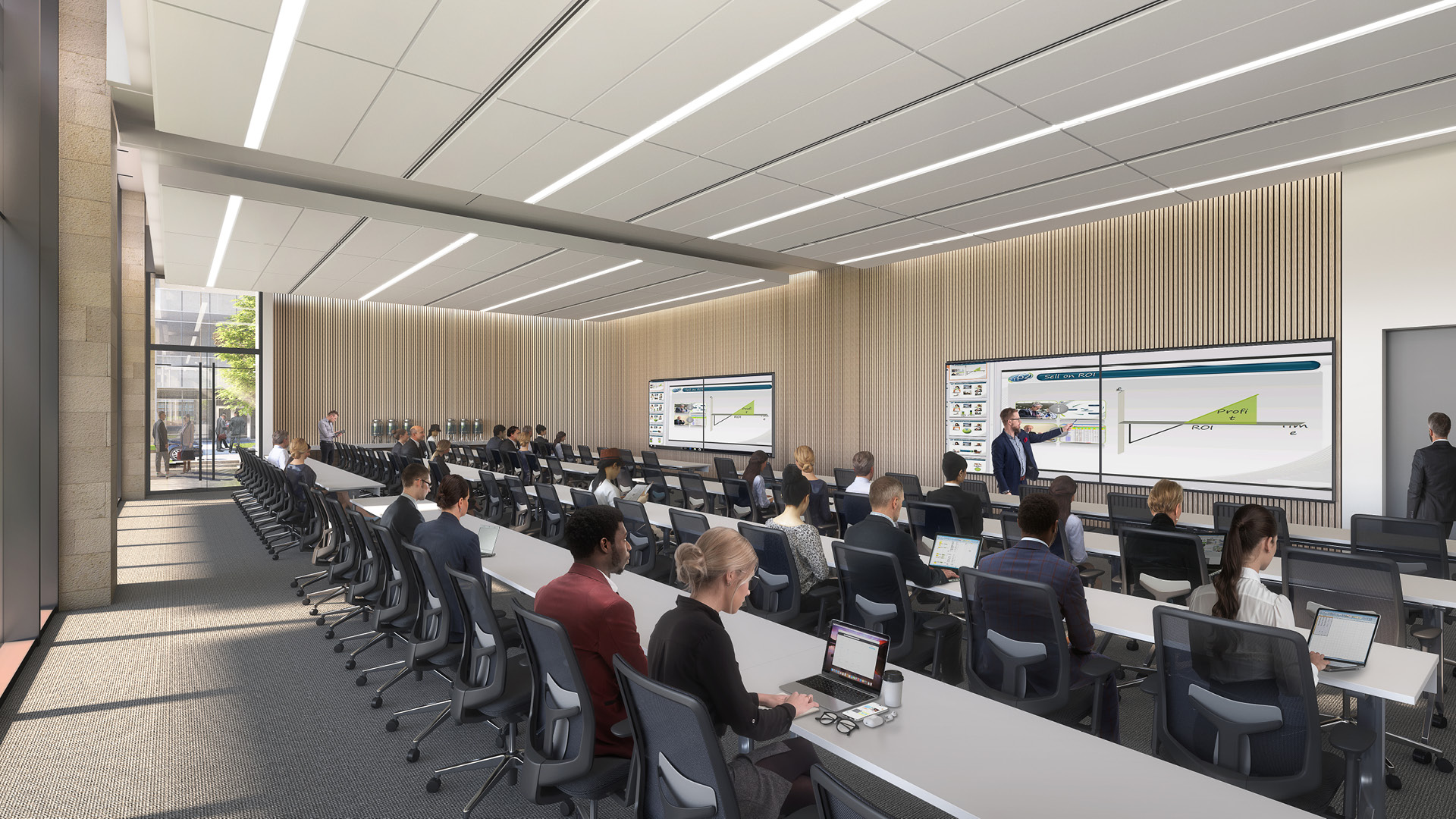 Conference room with long tables, chairs, and people attending a presentation.