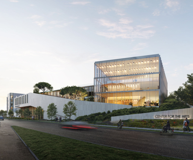 Street-level view of the Center for the Arts from the corner, showing the building's modern façade and surrounding greenery.