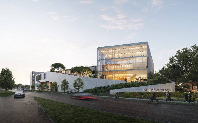 Street-level view of the Center for the Arts from the corner, showing the building's modern façade and surrounding greenery.