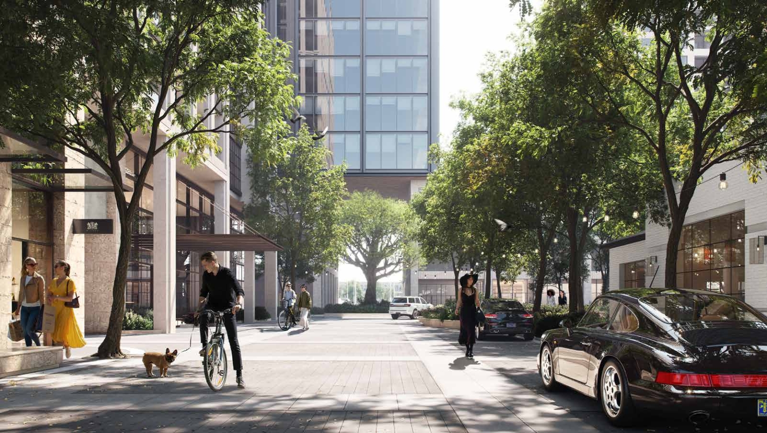 View of the motor court at Knox Promenade, lined with trees and featuring a mix of retail and residential spaces.