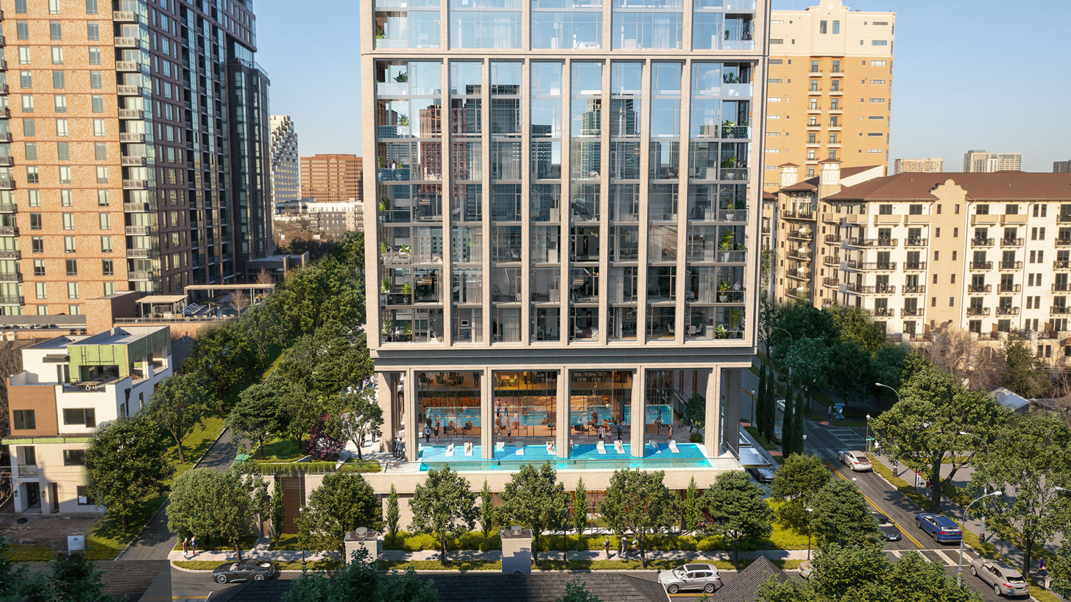 Daytime view of the elevated pool and amenity deck at Validus 2701 Brown, with glass windows and lush landscaping.