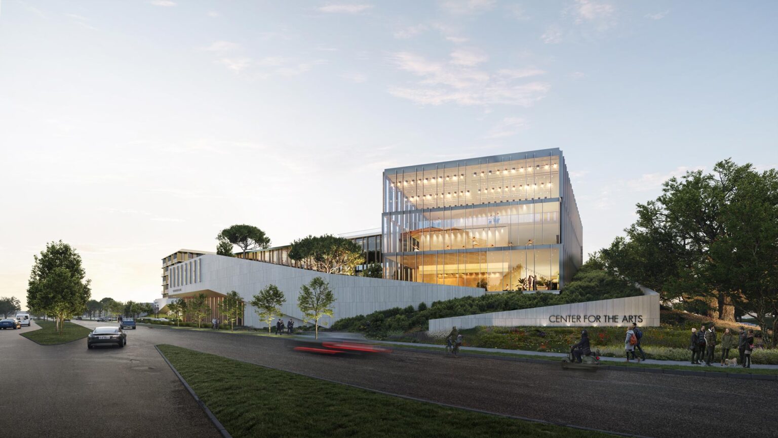 Exterior perspective of the Center for the Arts showing the glass-clad performance hall rising above a stepped concrete base, with landscaped terraces buffering the freeway and creating a prominent campus gateway.