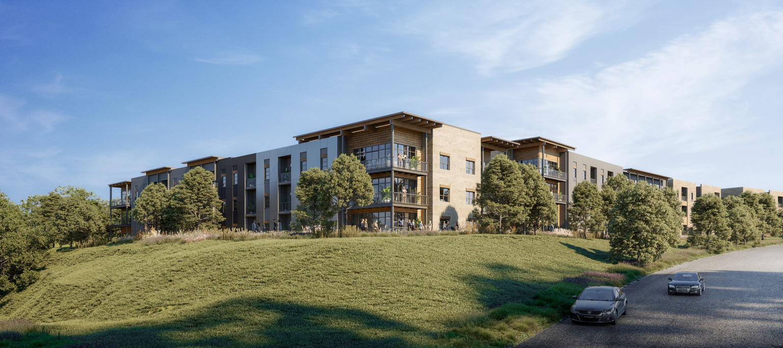 Corner view of Pearl Bee Cave multifamily buildings set against the Texas Hill Country, showcasing stone and rustic architectural finishes.