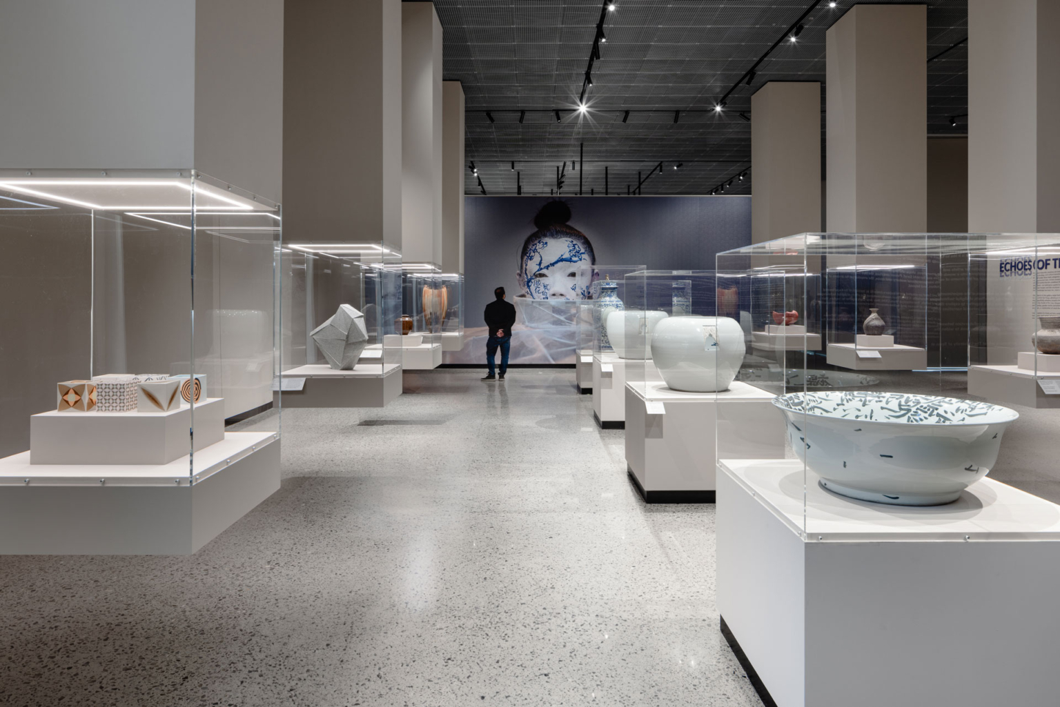 Exhibition gallery in UT Dallas Athenaeum Phase 1, displaying Asian artifacts in a museum setting.
