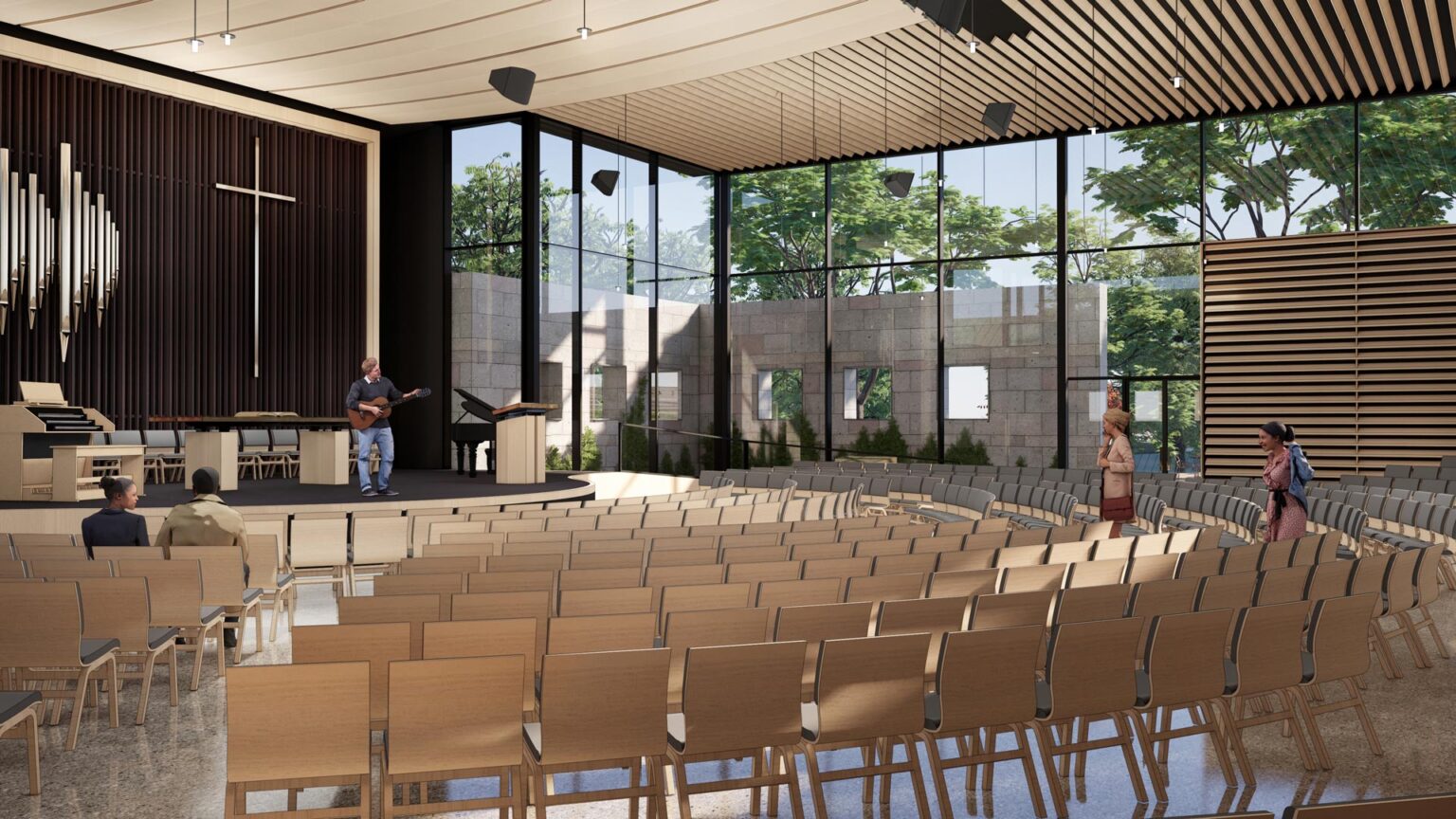 View from left side of Chapel interior showing layered seating, glass walls, and preserved stone garden structure.