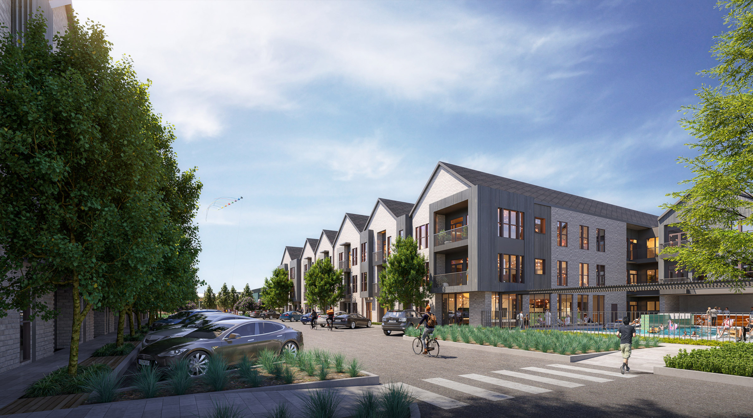 Street-level rendering of contemporary multifamily residences at Assembly Park, featuring a row of gabled buildings clad in a mix of stone, metal panels, and large windows. A landscaped streetscape with parked cars, bikers, and pedestrians enhances the walkability of the area. In the foreground, a pool and lounge space are enclosed by a low fence.