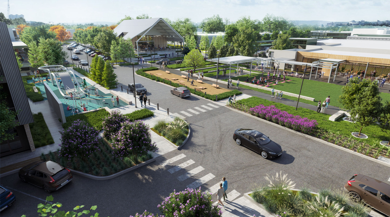 Elevated rendering of Assembly Park’s central streetscape, featuring a children’s play area with modern climbing structures, a large open green space with seating, and a fitness lawn where people are gathered for outdoor activities. Tree-lined streets, pedestrian walkways, and surrounding buildings frame the vibrant public realm.