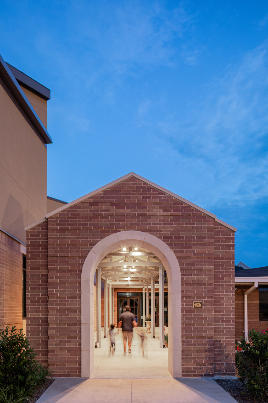 Close-up of the loggia, a brick and cast stone portal leading to the main entrance of the church.