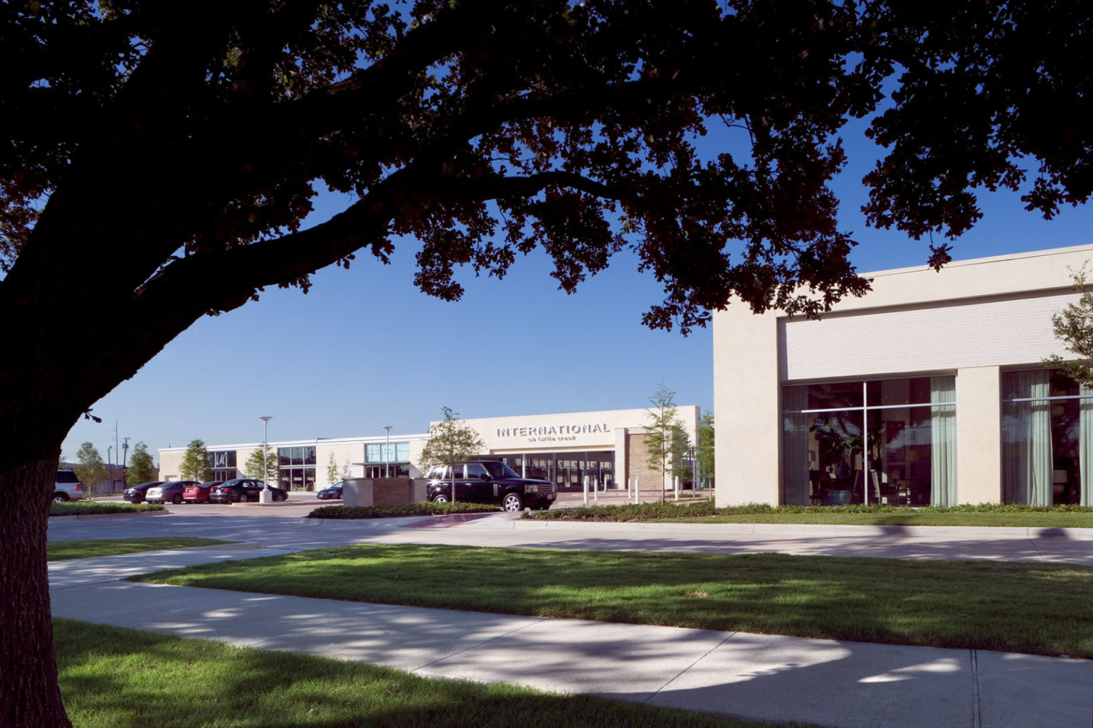 Front view of the refurbished warehouse exterior, featuring white-painted brick and glass walls.