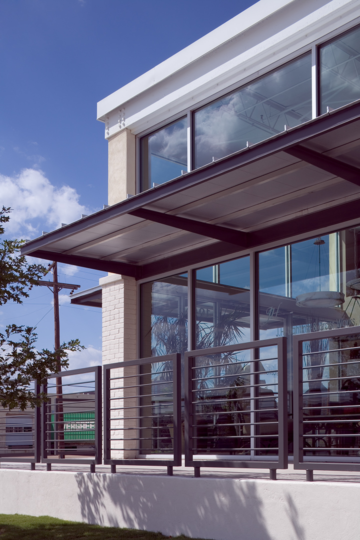 Close-up of a modern glass storefront with a steel canopy, blending industrial and contemporary elements.