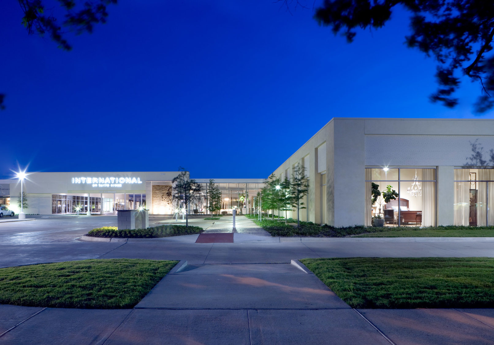 Evening view of the main entry to the International on Turtle Creek, with soft lighting and landscaped pathways.