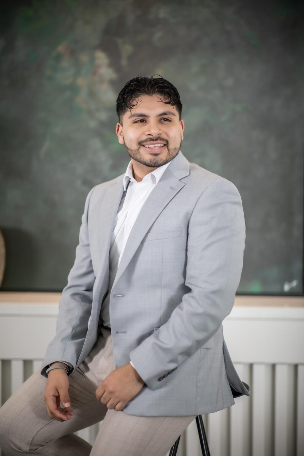 Jorge Herrera, Architectural Professional at GFF, seated in a modern Dallas office setting, early-career architect supporting the Planning team.