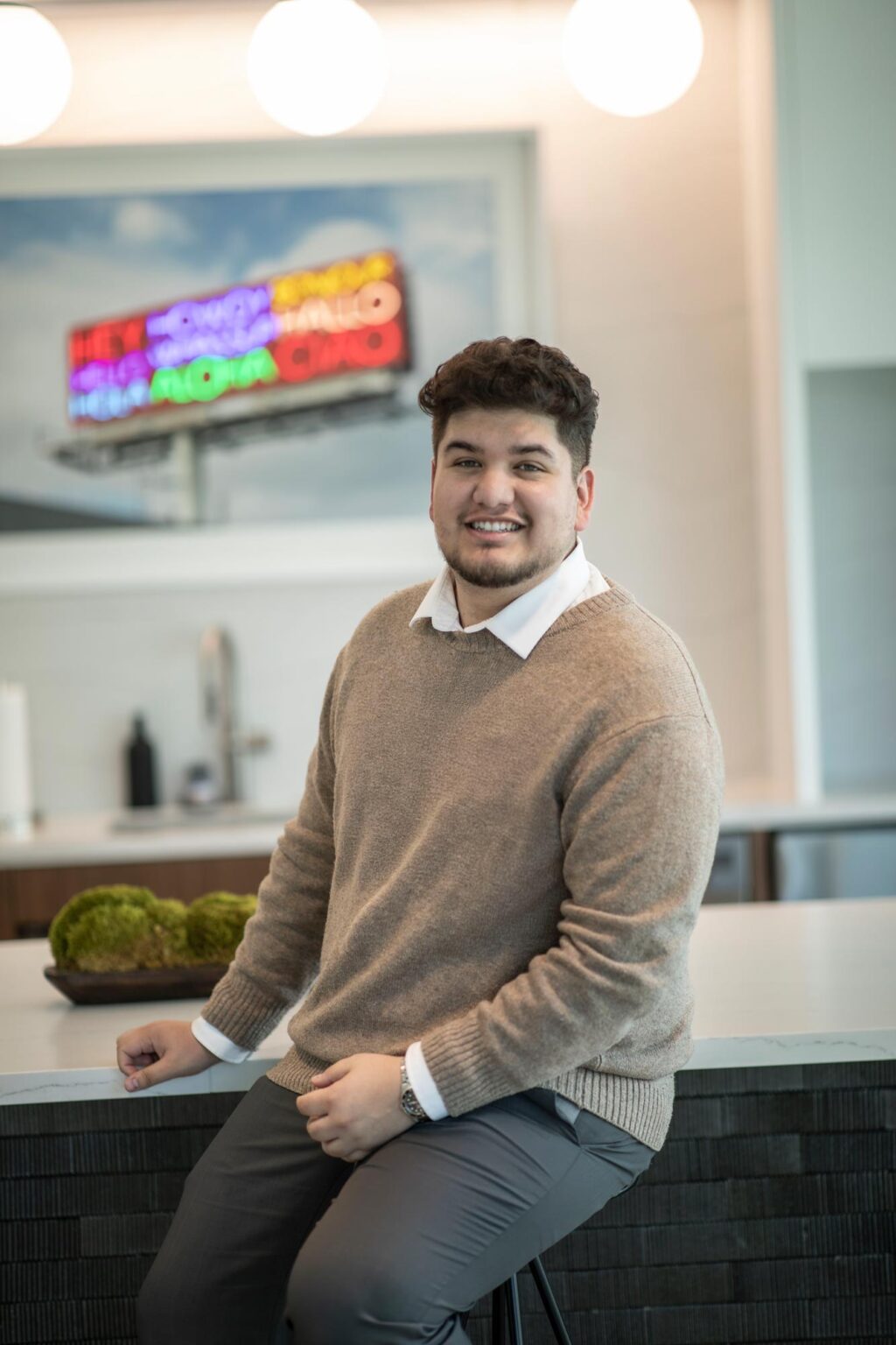 Marc Loya-Reyes, Architectural Professional at GFF, photographed seated in a modern Dallas office interior at a leading design firm.