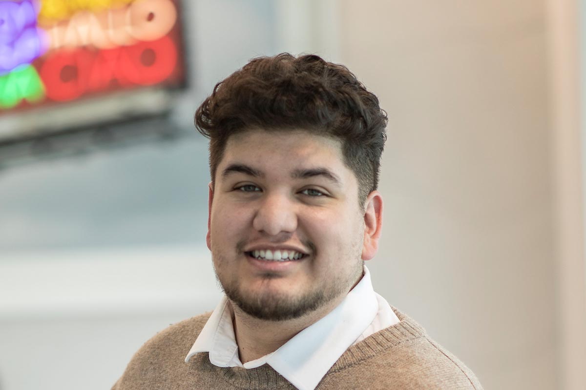 Marc Loya-Reyes, Architectural Professional at GFF Dallas, close-up professional portrait in a modern design firm workplace.