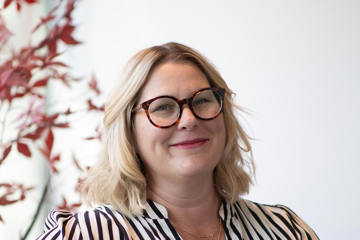 Erin Nies, Associate and Senior Project Leader at GFF Austin, close-up professional portrait in a modern design firm setting.